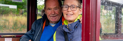 A couple travelling in a carriage on the Bure Valley Railway