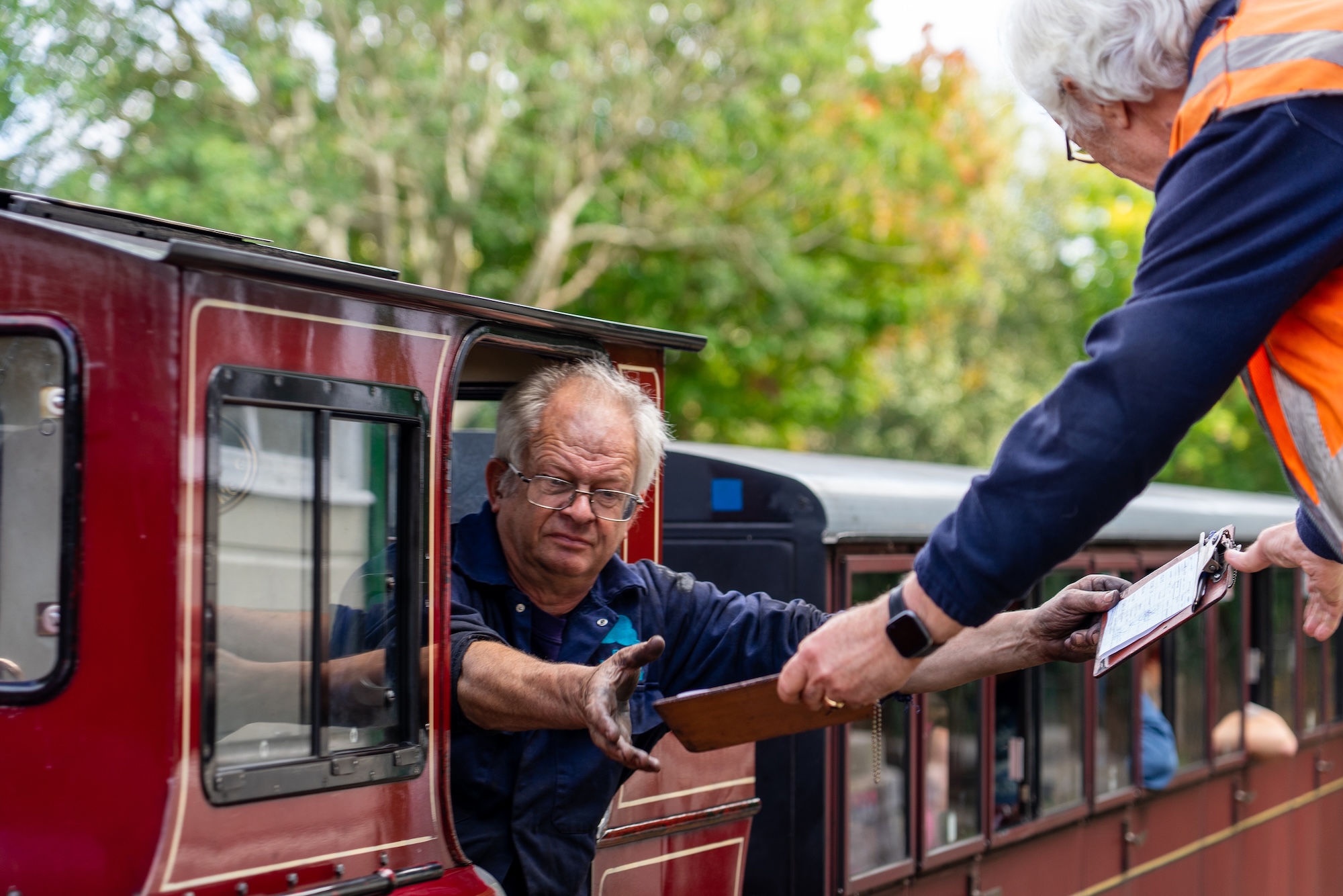 Engineer Exchanging The Train Staff Token With Station Staff