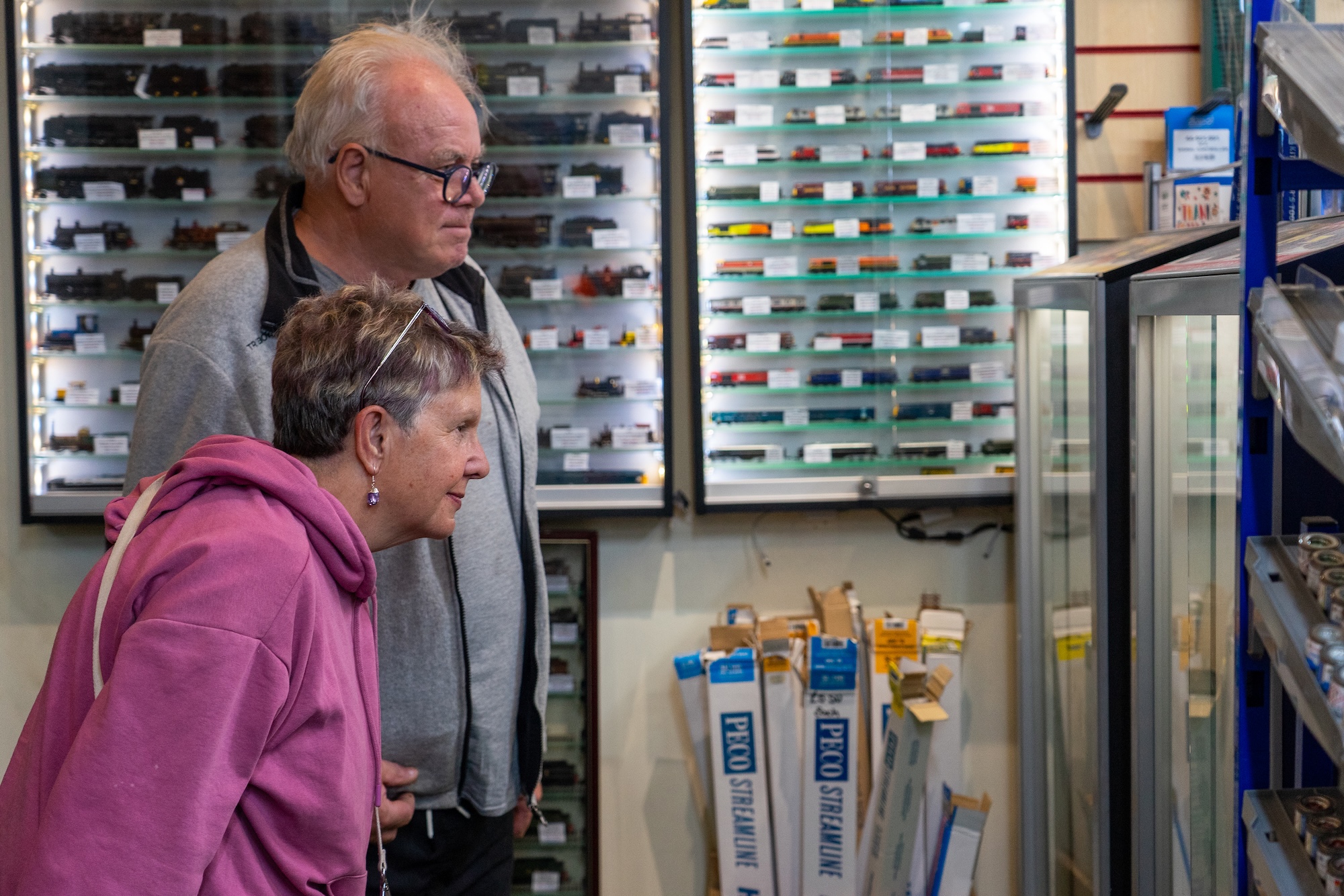 Visitors Looking At Model Railway Displays And Locomotives In Glass Cabinets