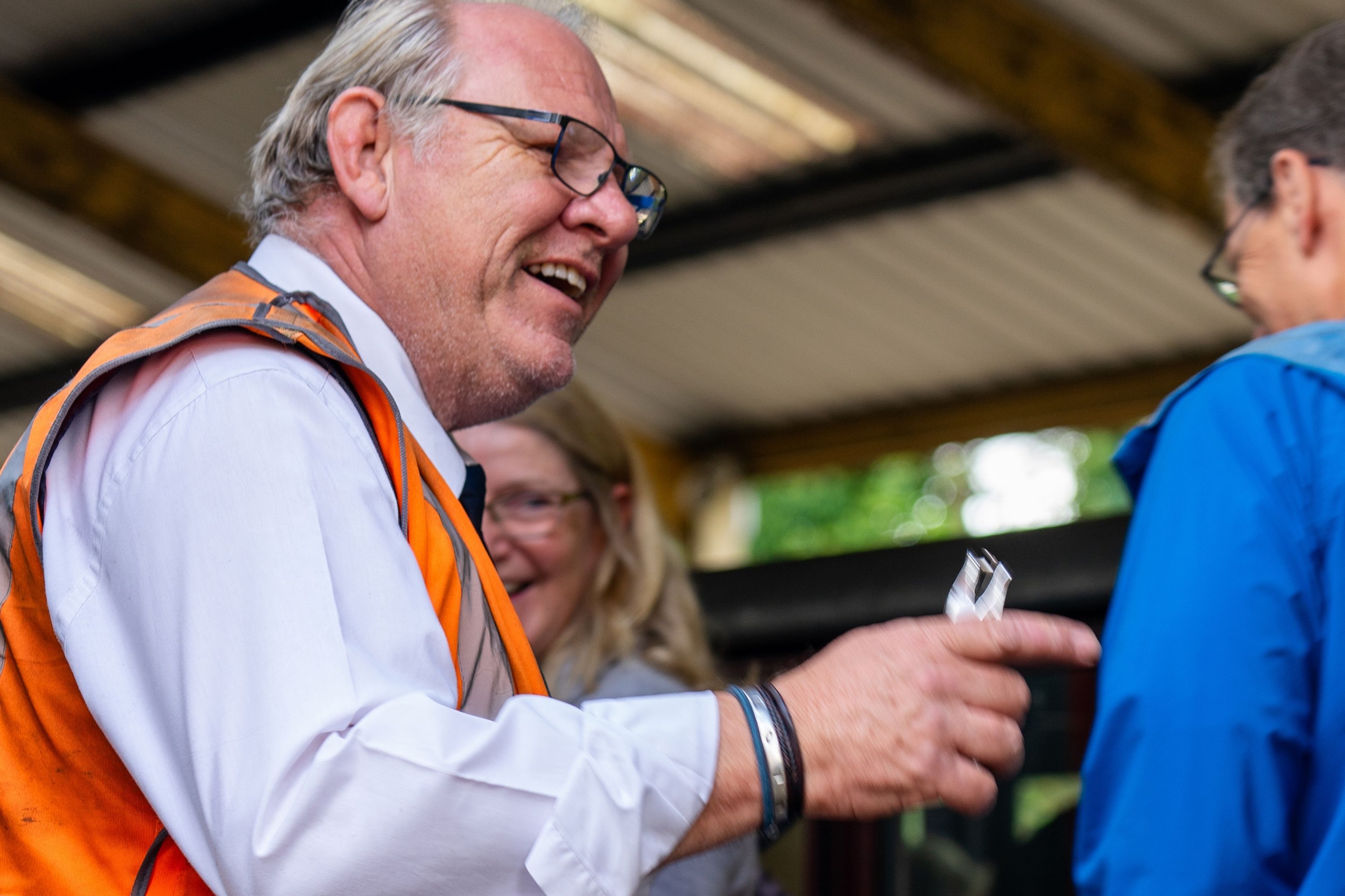 Conductor Checking A Ticket With Smiles
