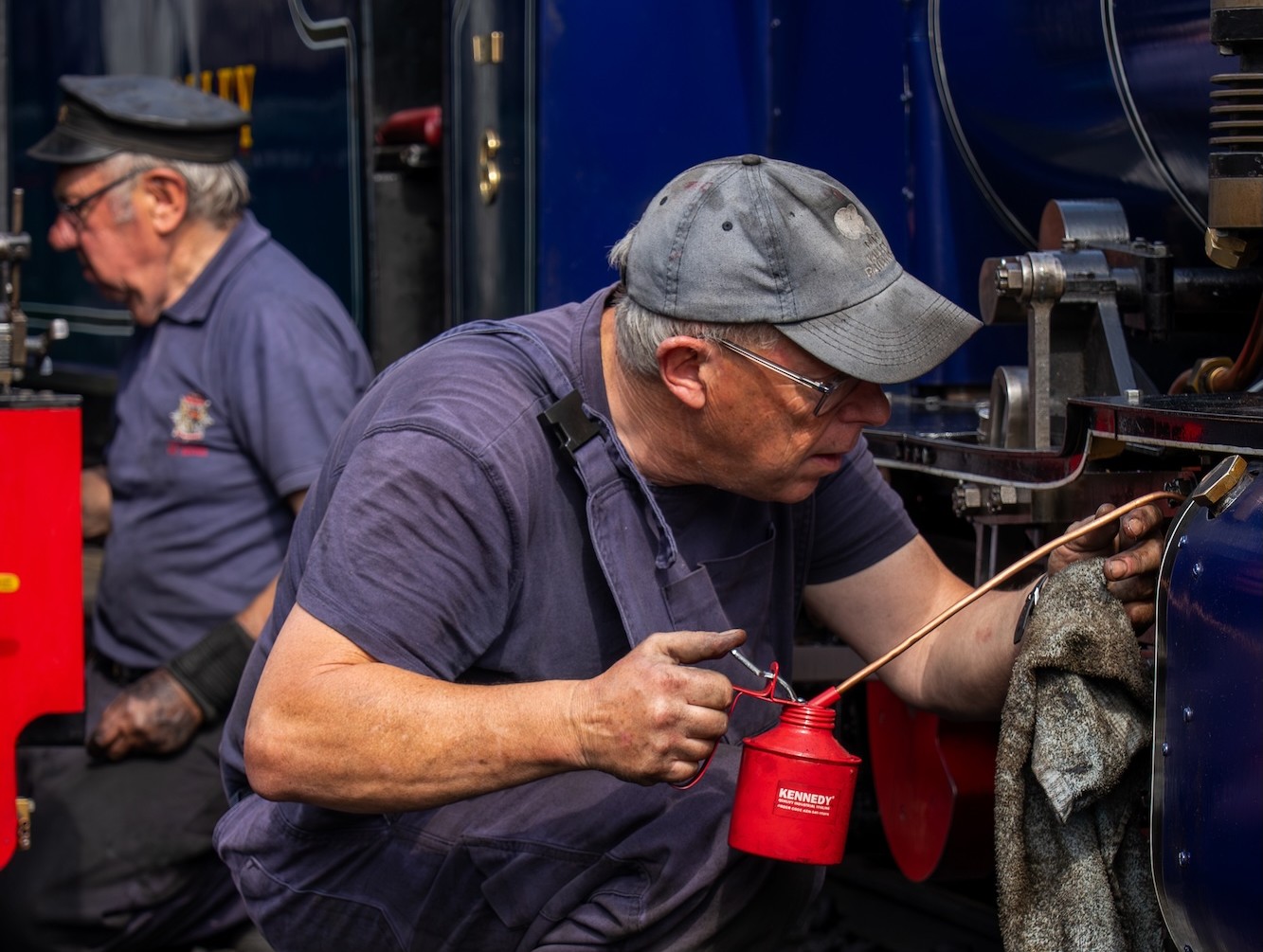 Railway Volunteer Oiling And Maintaining A Steam Locomotive
