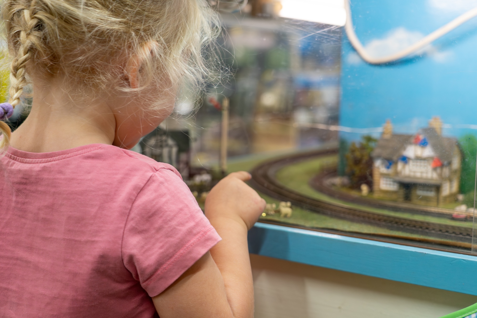 Child Watching A Model Railway Layout Display Inside The Shop