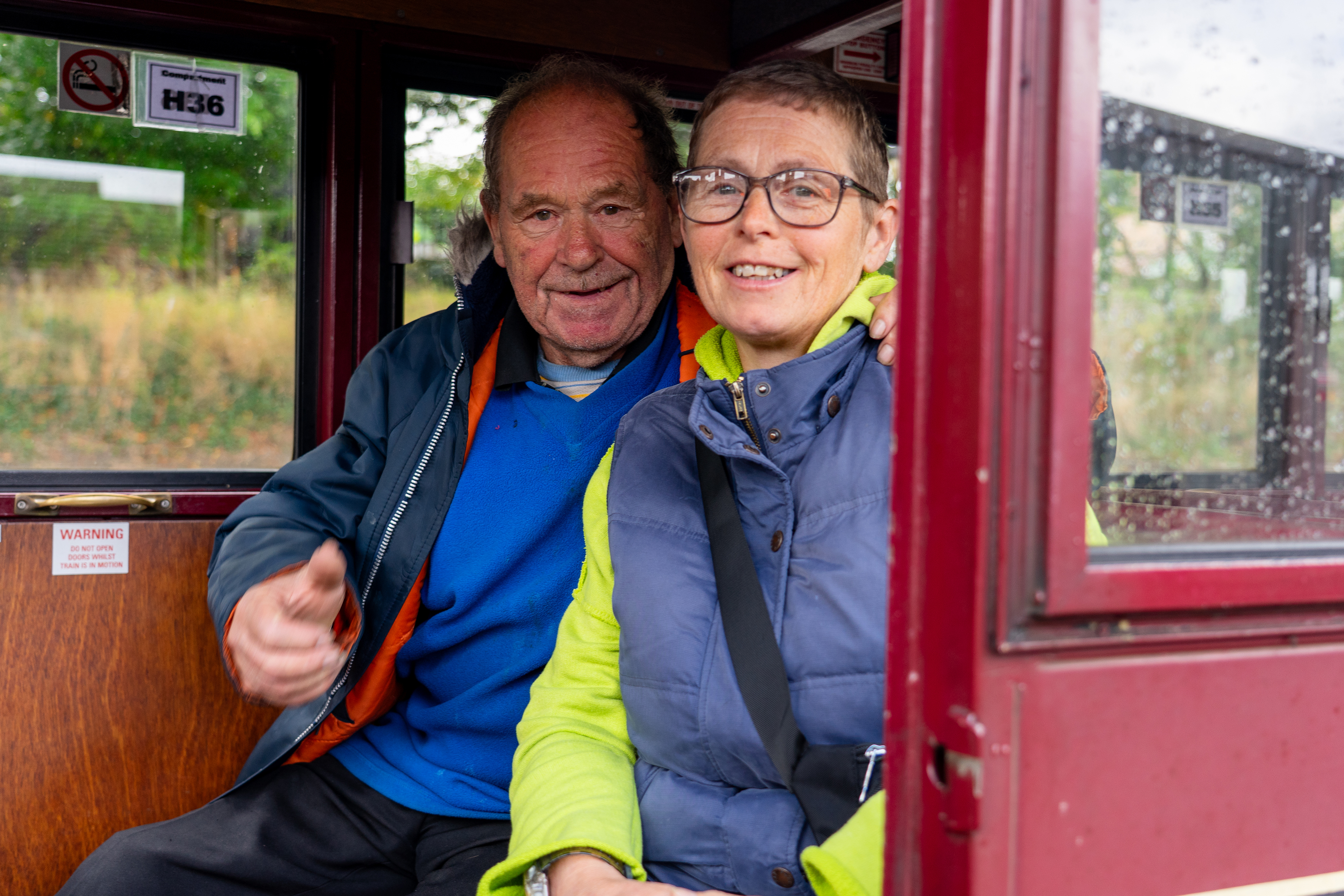 Couple onboard a carriage ready to travel to Wroxham Station