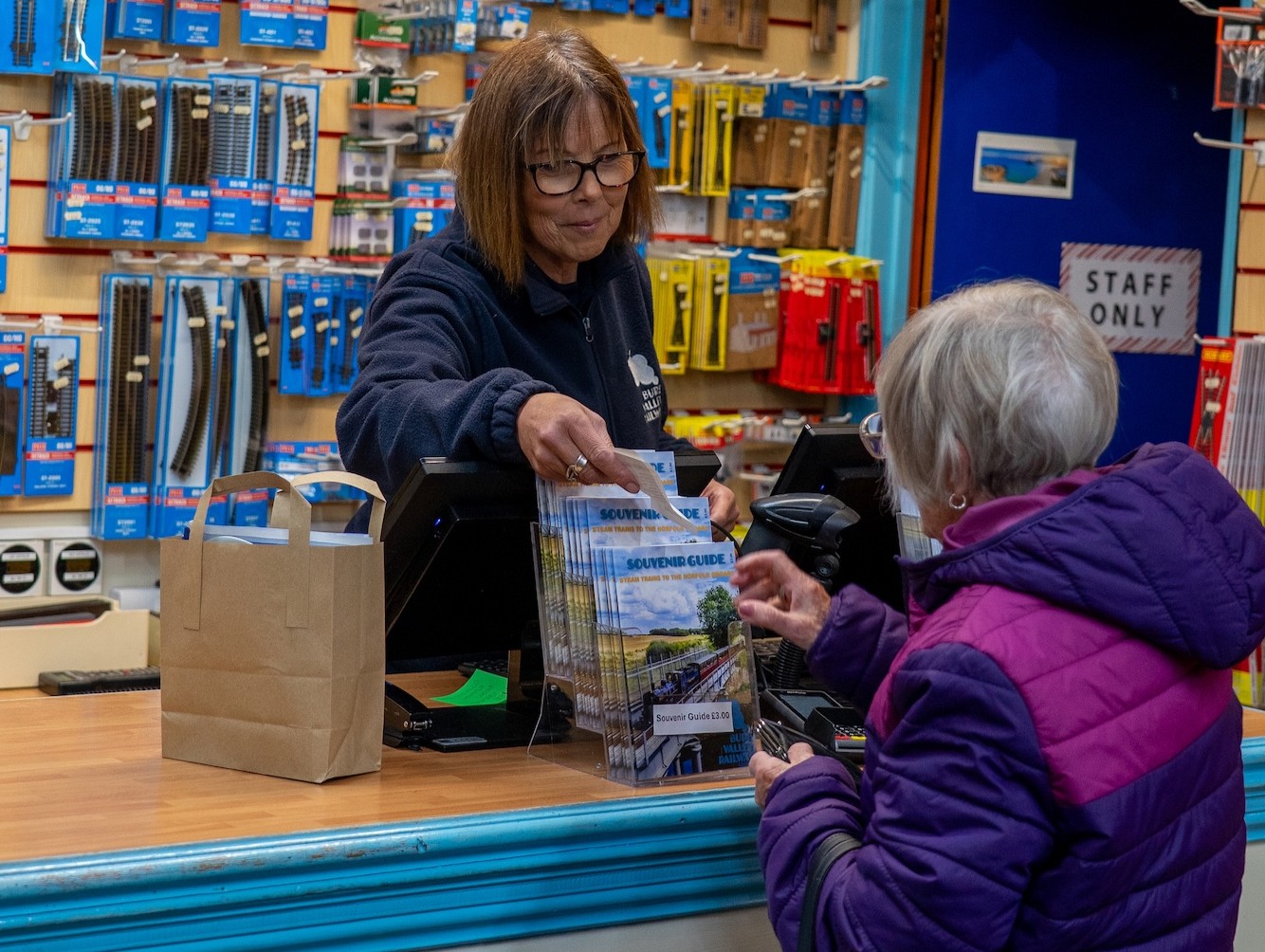 Staff Member Helping A Customer At The Counter In The Model Railway Shop