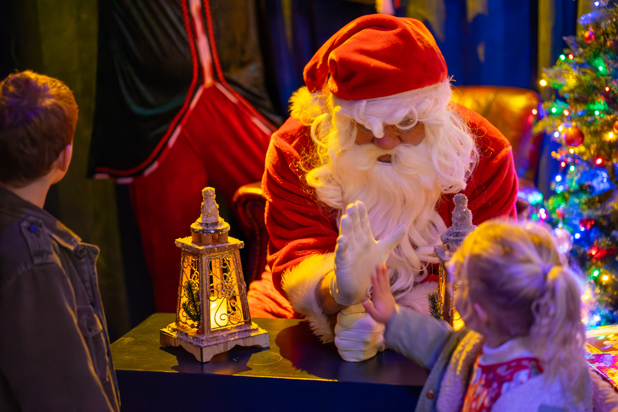 Father Christmas at Santa's Grotto giving out presents at Bure Valley