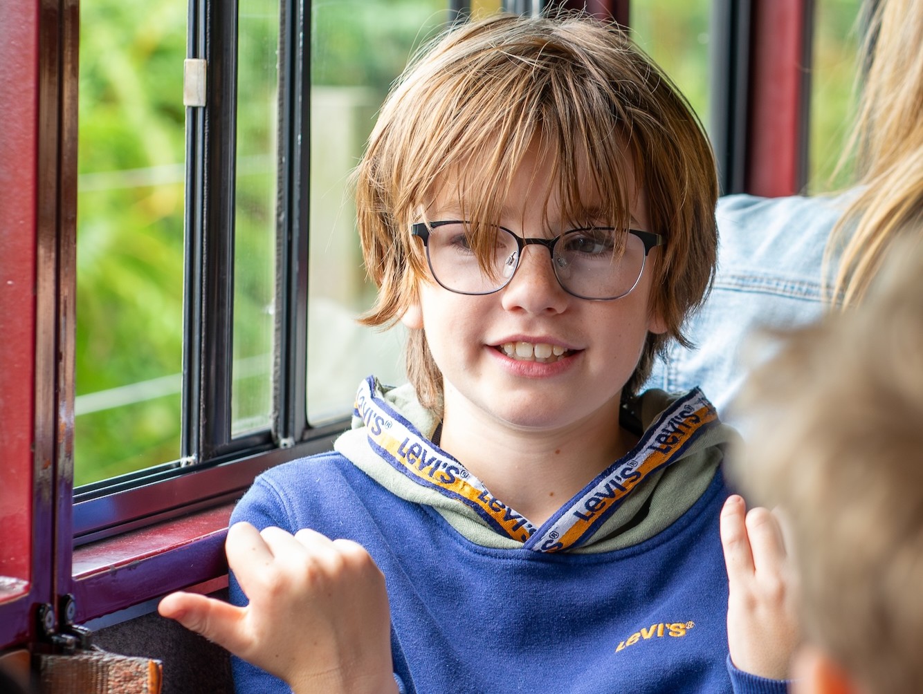 Child Sitting Beside The Carriage Window
