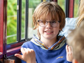 Child Sitting Beside The Carriage Window